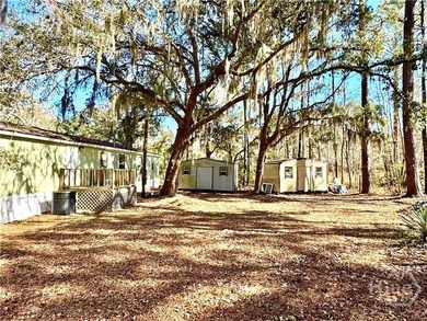 Sitting on a full acre with beautiful mature oaks, this home - photo 8