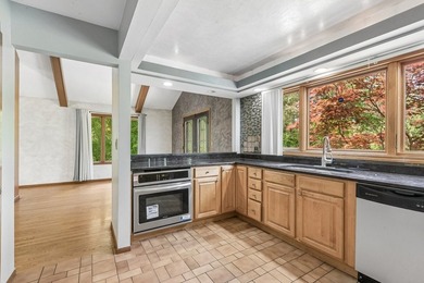 This contemporary 5-bedroom, 2.5-bath home sits on 1.4 wooded - photo 12