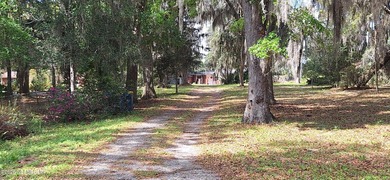 Lakefront views and exceptional privacy on a 1.4-acre lot can be - photo 4