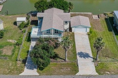 Canal front property with boat launch. This two-story, two-lot