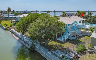 Canal front property with boat launch. This two-story, two-lot