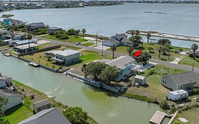 Canal front property with boat launch. This two-story, two-lot