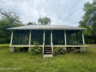 Tucked beneath a canopy of mature trees in the heart of Waveland - photo 1