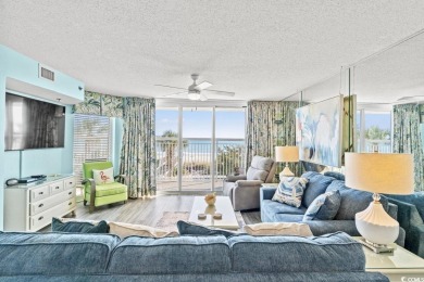 Step right onto the sand from this desirable first-floor, direct