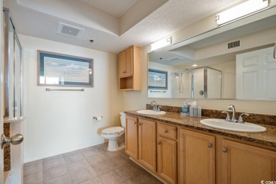 Step right onto the sand from this desirable first-floor, direct