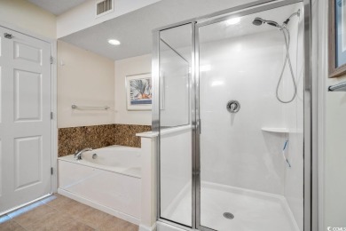 Step right onto the sand from this desirable first-floor, direct