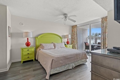 Step right onto the sand from this desirable first-floor, direct