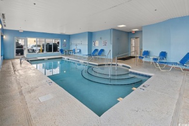 Step right onto the sand from this desirable first-floor, direct