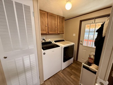 This charming home sits on 1 acre of unrestricted land, offering