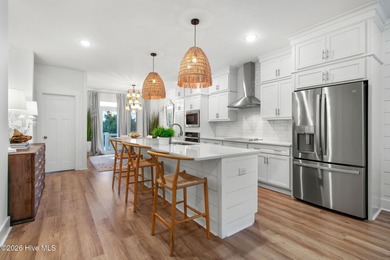 Beautifully upgraded end-unit townhome built in 2023, this Inlet