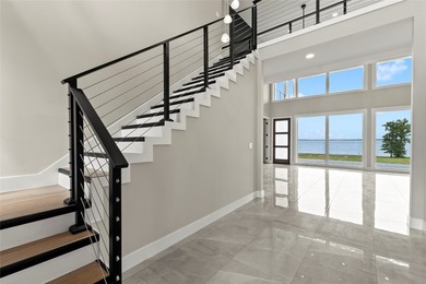 Positioned on 1.5 acres in a gated waterfront community designed - photo 3