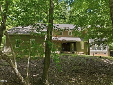 Tucked away on 5 private wooded acres with a peaceful pond, this - photo 2