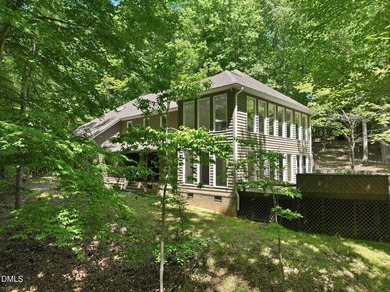 Tucked away on 5 private wooded acres with a peaceful pond, this - photo 3