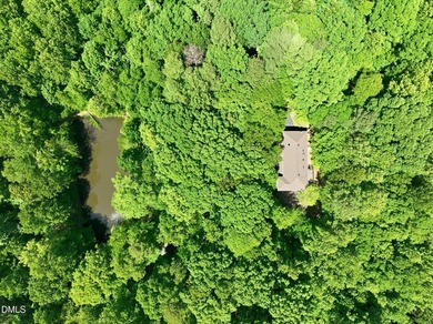 Tucked away on 5 private wooded acres with a peaceful pond, this - photo 5