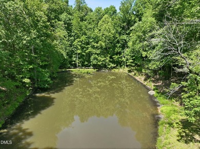 Tucked away on 5 private wooded acres with a peaceful pond, this - photo 6