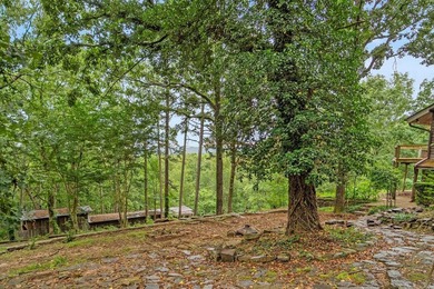 Nestled on 5 private wooded acres, this custom log home offers - photo 42