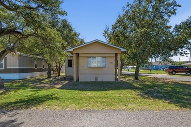 Cute mobile home with a new engineered roof placed over home - photo 2