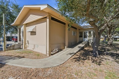 Cute mobile home with a new engineered roof placed over home - photo 6