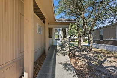 Cute mobile home with a new engineered roof placed over home - photo 7
