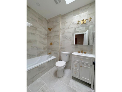 Experience modern luxury in this fully renovated two-family - photo 7