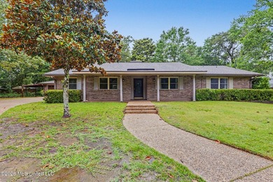 Situated on a quiet cul-de-sac in the heart of Diamondhead, this - photo 1