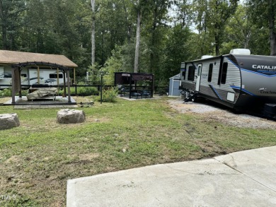 Beautiful fenced lot boasting a 2022 Catalina Legacy Camper with - Lake Lot For Sale in Louisburg, North Carolina