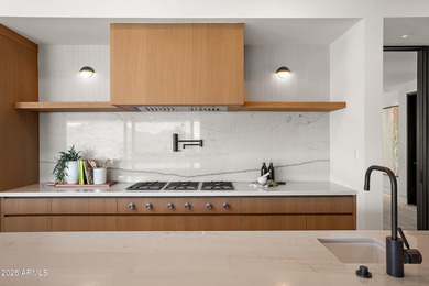 Perched high in the prestigious Tatum Canyon, this modern