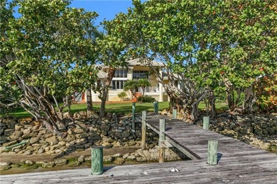 Framed by swaying palms and endless water views, this estate - photo 29