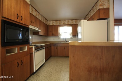 This charming single-level brick home in the highly desirable