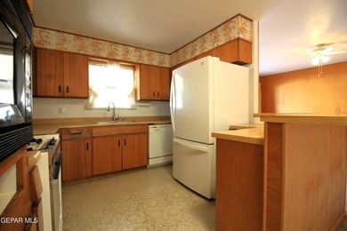 This charming single-level brick home in the highly desirable