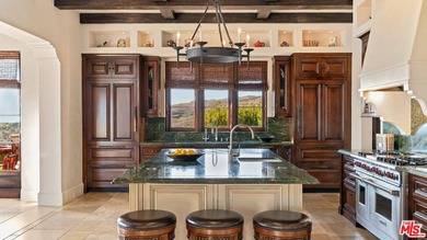 Enter through a grand metal, glass, and wood front door framed - photo 17