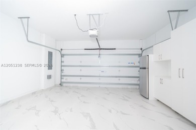 Features: The garage includes finished flooring, air - photo 5