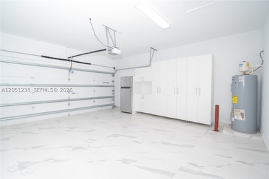 Features: The garage includes finished flooring, air - photo 6