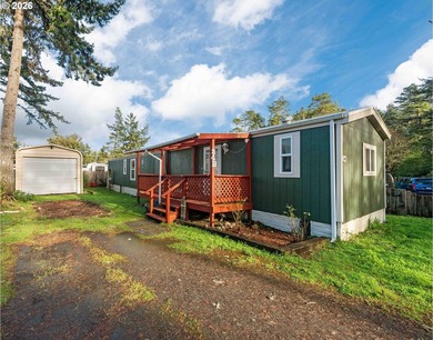 This well cared-for manufactured home in Dunes Mobile offers a - photo 1