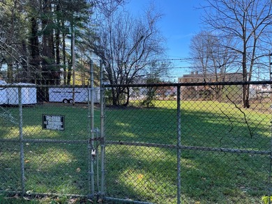 Restaurant building and fenced acreage in the back. Large corner