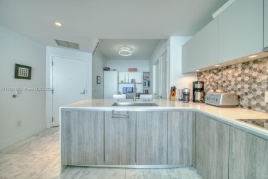 Experience breathtaking Biscayne Bay views from this 2 bed + den