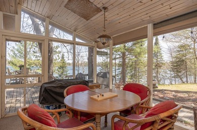 On the shores of beautiful Woman Lake, this home captures the - photo 17