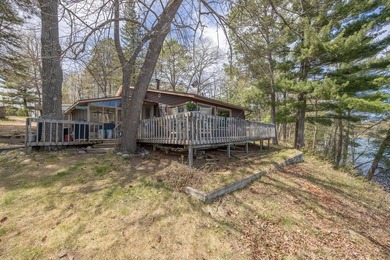 On the shores of beautiful Woman Lake, this home captures the - photo 28