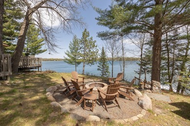 On the shores of beautiful Woman Lake, this home captures the - photo 32