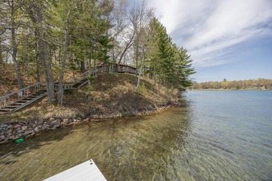 On the shores of beautiful Woman Lake, this home captures the - photo 34