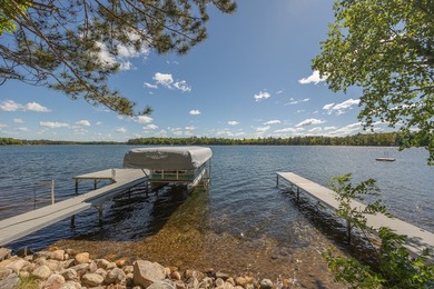 On the shores of beautiful Woman Lake, this home captures the - photo 35