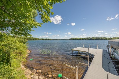 On the shores of beautiful Woman Lake, this home captures the - photo 36