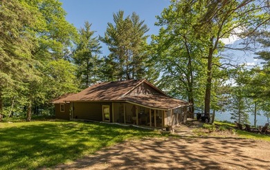 On the shores of beautiful Woman Lake, this home captures the - photo 43