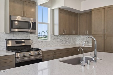 Open-concept living with high ceilings, wide-plank laminate