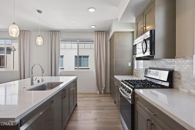 Open-concept living with high ceilings, wide-plank laminate