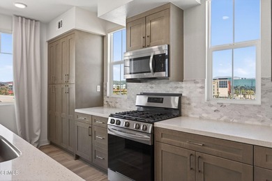 Open-concept living with high ceilings, wide-plank laminate