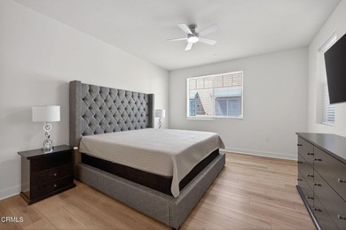 Open-concept living with high ceilings, wide-plank laminate