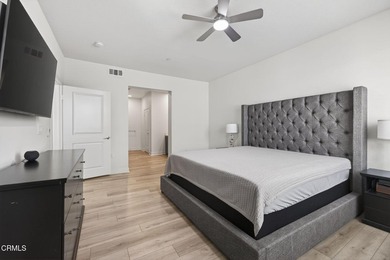 Open-concept living with high ceilings, wide-plank laminate