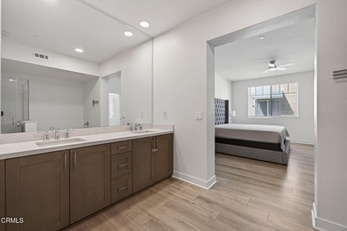 Open-concept living with high ceilings, wide-plank laminate