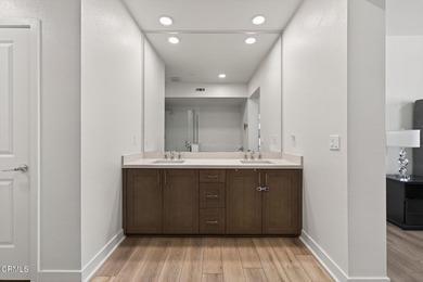 Open-concept living with high ceilings, wide-plank laminate